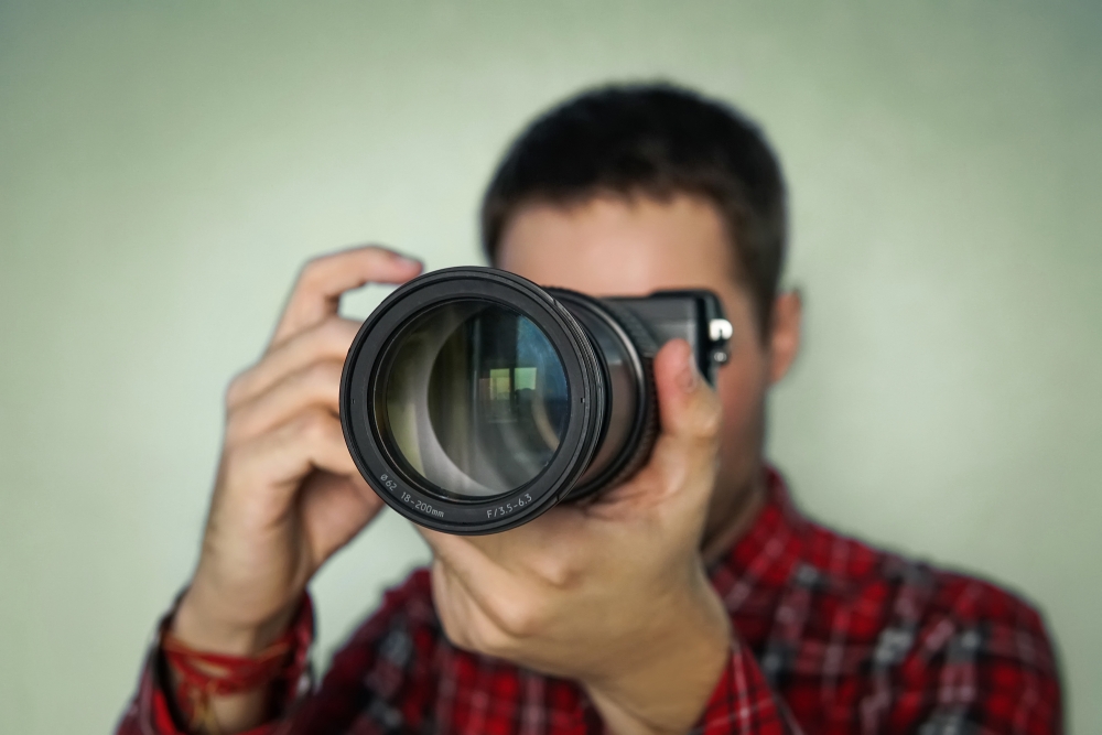 bigstock-Photographer-Holding-Mirrorles-240469207